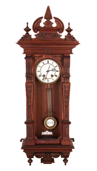 Antique wall clock with a pendulum in a carved wooden housing.