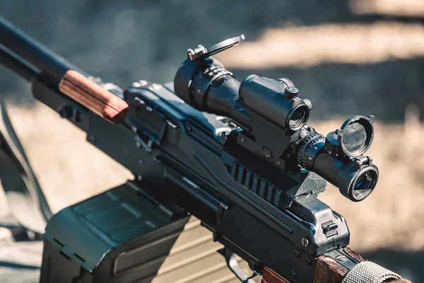 Machine gun with optical sight closeup.