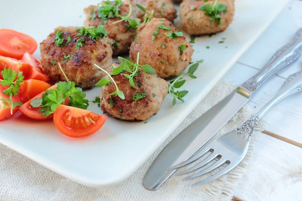 Meatballs with fresh herbs on a plate