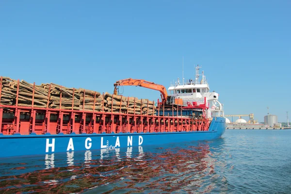 Ship loaded by wood logs in port of Gdynia, Poland