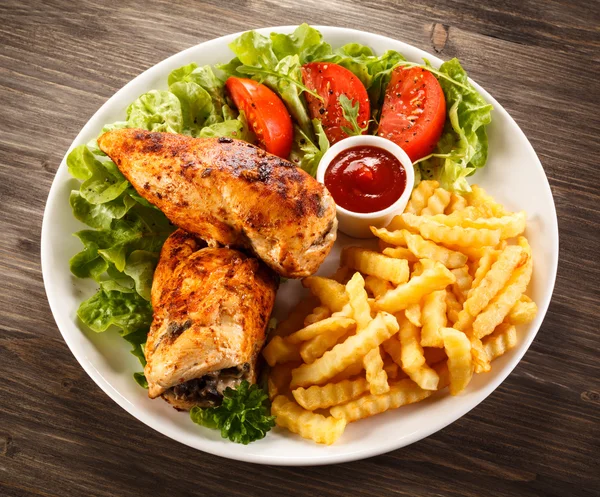 Roasted chicken breast, French fries and vegetables