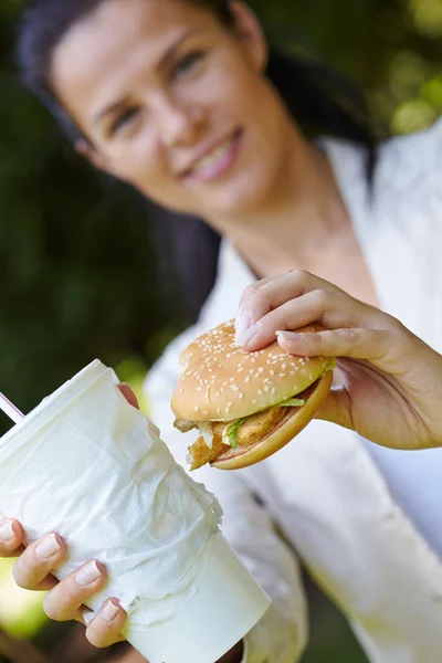 Woman eating hamburger