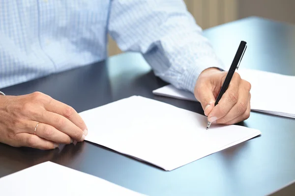 Man with pen and paper sheet