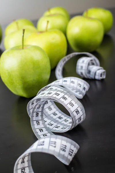 Apples with measuring tape