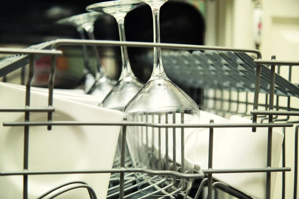 Details of Open dishwasher with clean utensils