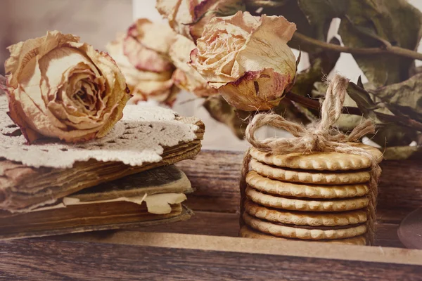 Vintage old books, roses and cake