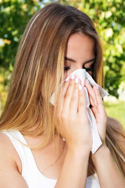 Girl blowing nose