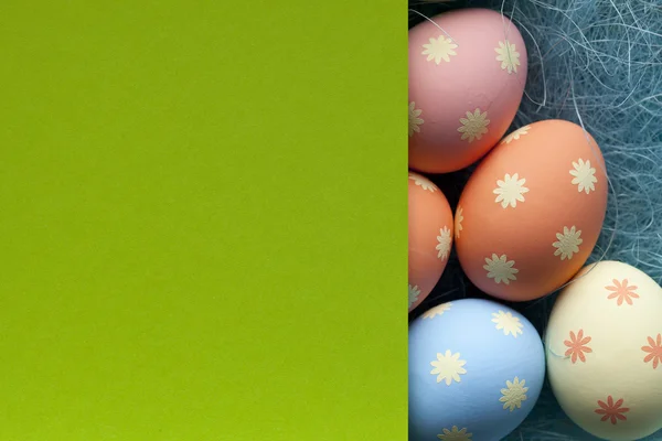 Blank green paper and colored Easter eggs