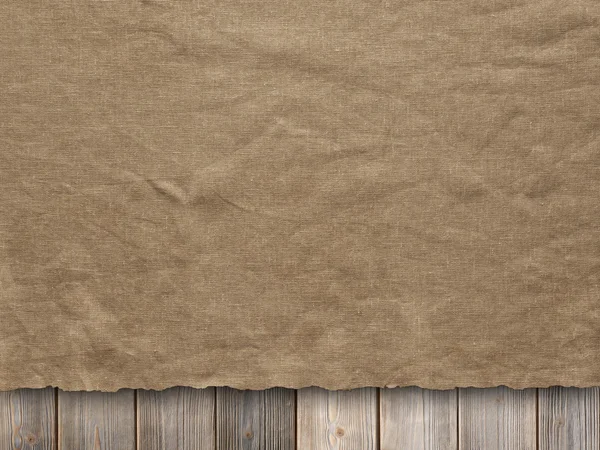Creased fabric on wooden wall background