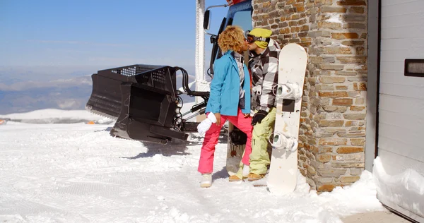 Couple kissing behind ski resort