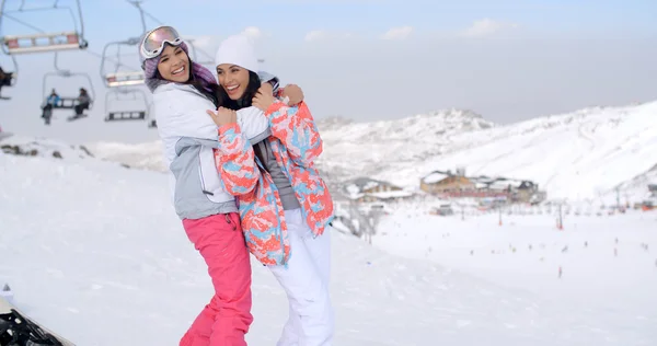 Two playful ladies at ski resort