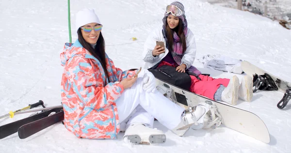 Women sitting on mountain top in snow