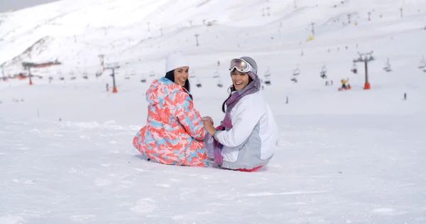 Women sitting on mountain top in snow