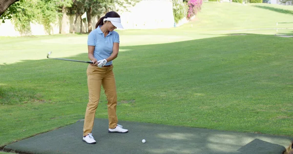 Female golfer preparing to tee off