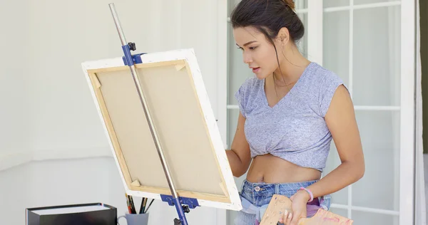 Young woman working on painting