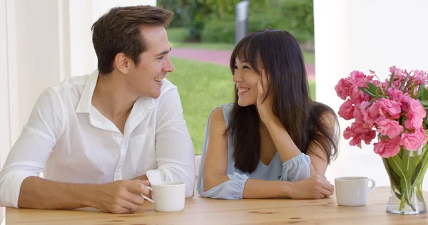 Young adult couple sitting at table