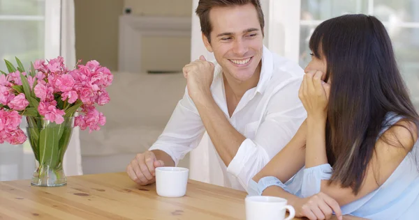 Adult couple sitting at table