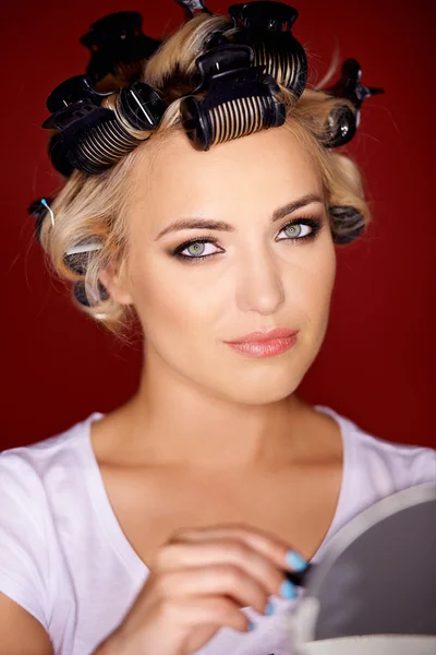 Beautiful young blond with her hair in curlers