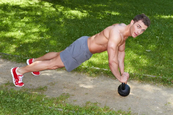 Athletic Young Man Exercising at the Park