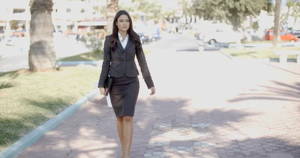 Businesswoman walking down street