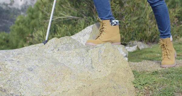 Person in hiking boots at mountains