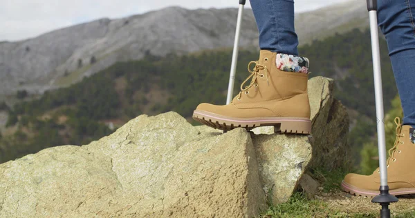 Person in hiking boots at mountains