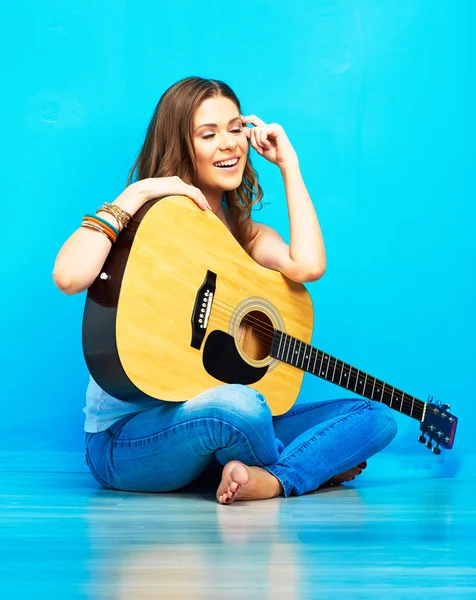 Woman sitting with guitar