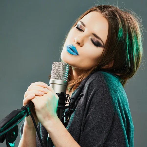 Beautiful woman with microphone.