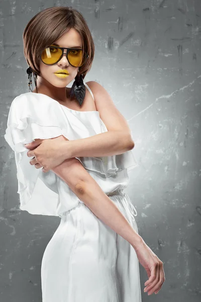 Fashion model posing in white dress