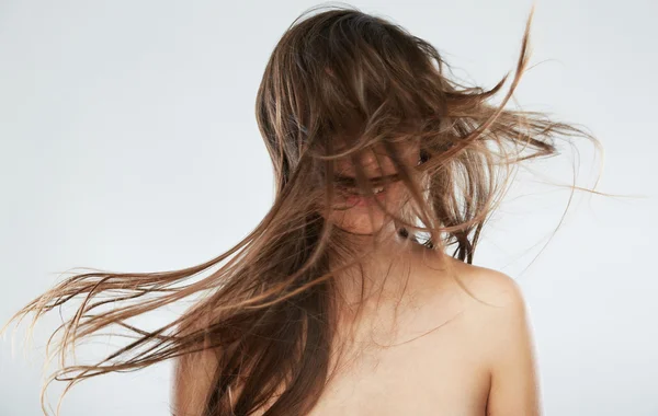Woman posing with blowing hair