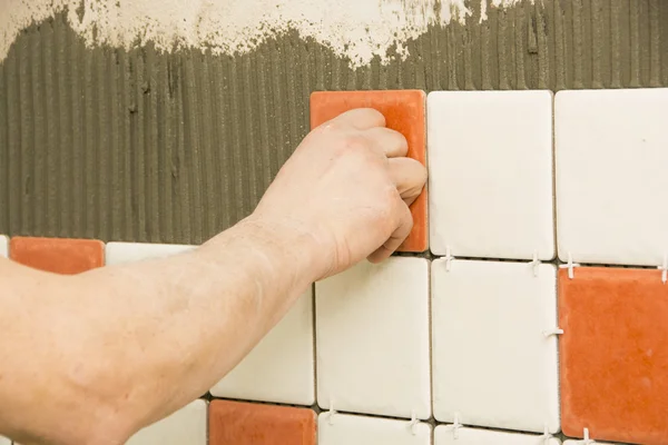 Man installing ceramic tile