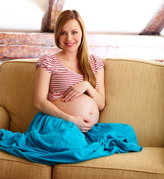 Pregnant Woman Sitting On Couch