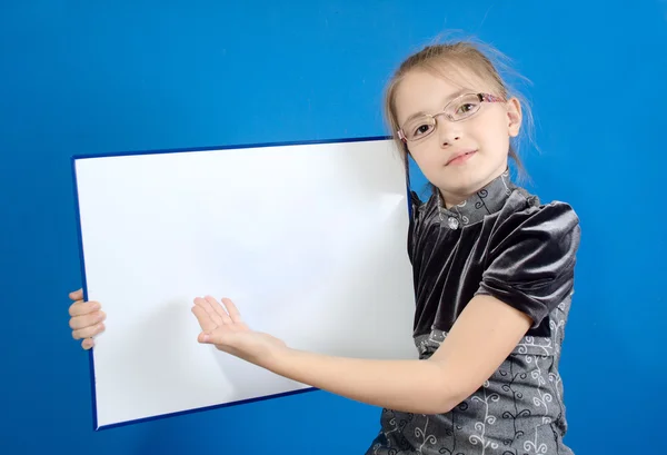 The girl shows a white plastic board