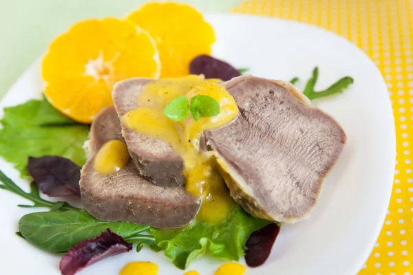 Boiled beef tongue with orange sauce