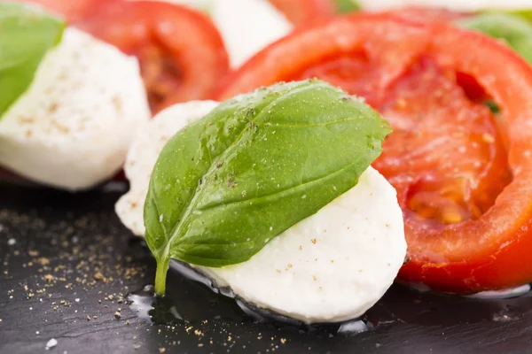 Caprese salad with mozzarella, tomato, basil and balsamic vinega