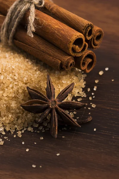 Cinnamon sticks with pure cane brown sugar on wood background
