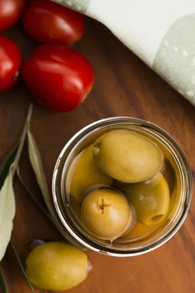 Pickled olives and olive tree branch