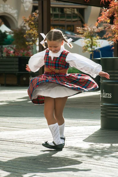 The dancing girl in latvian traditional suit