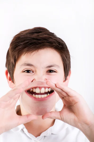 Boy holding a magnifying glass to his mouth