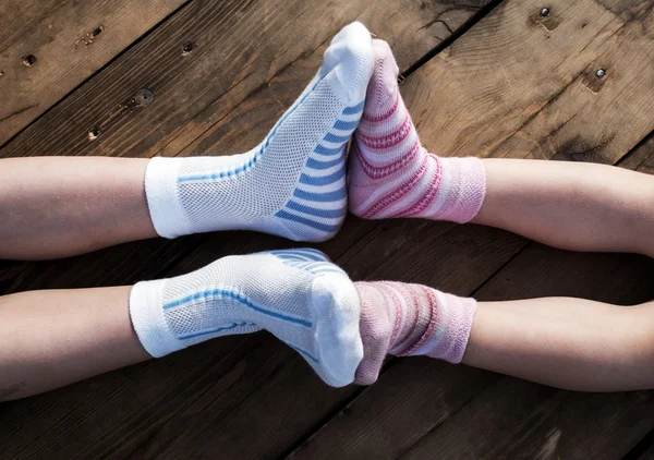 Child legs in colorful striped socks
