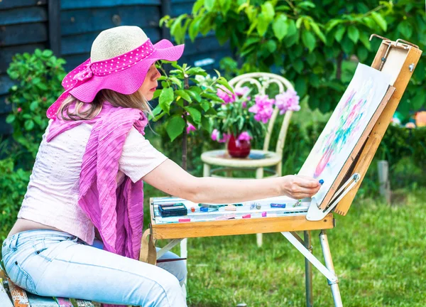 Fashion woman is painting. Open air session