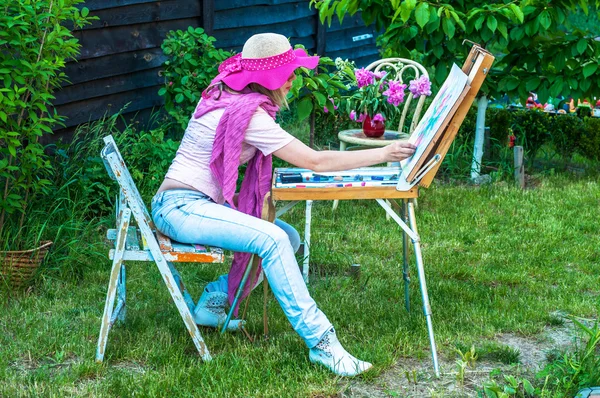 Fashion woman is painting. Open air session