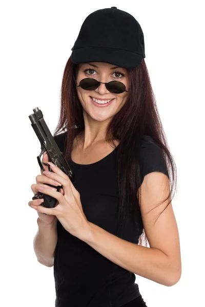 Smiling young woman with a gun