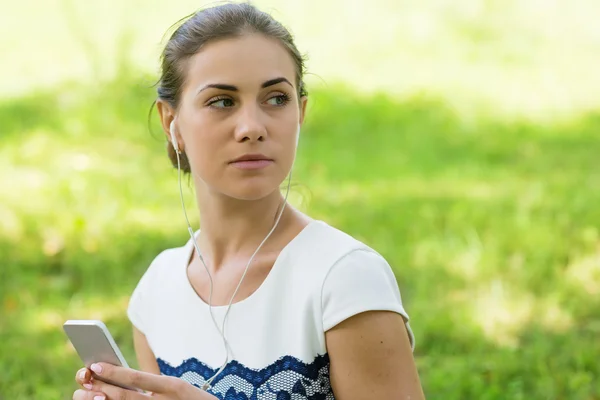 Girl listening to music streaming with headphones