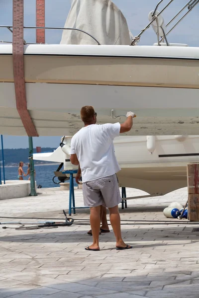 Man painting a boat