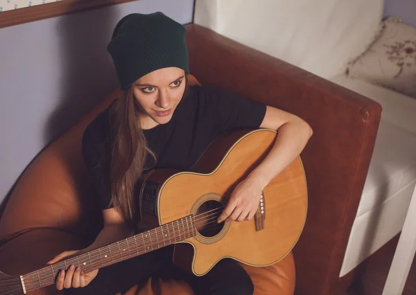 Woman playing on guitar