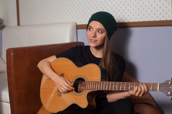 Woman playing on guitar