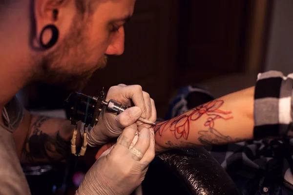 Tattoo artist works in salon