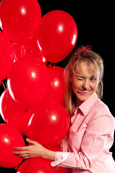 Pretty woman in blouse with red balloons