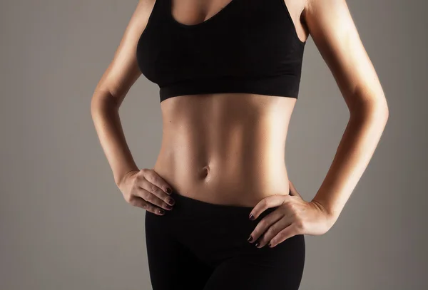 Athlete showing perfect slim stomach